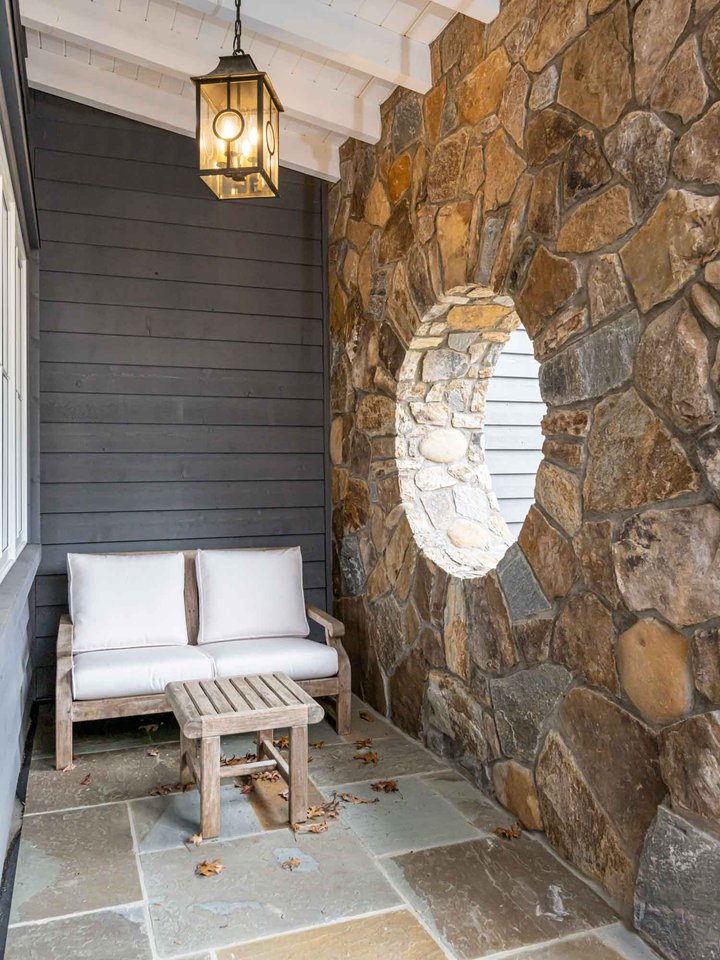 Blue beauty exterior foyer with stone wall