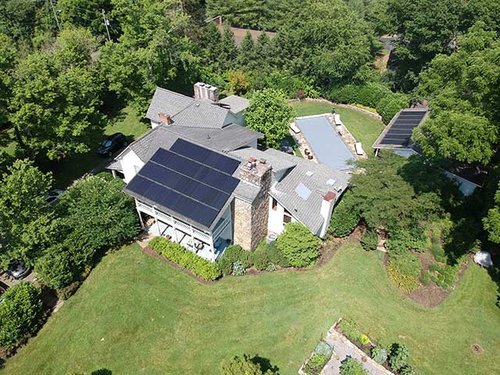 Aerial drone view of home with solar panels installed.