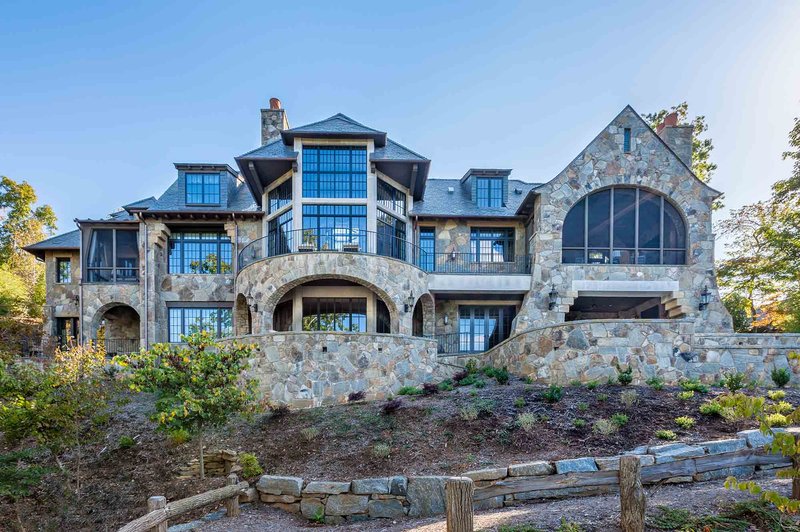 Large, stately stone home with expansive windows