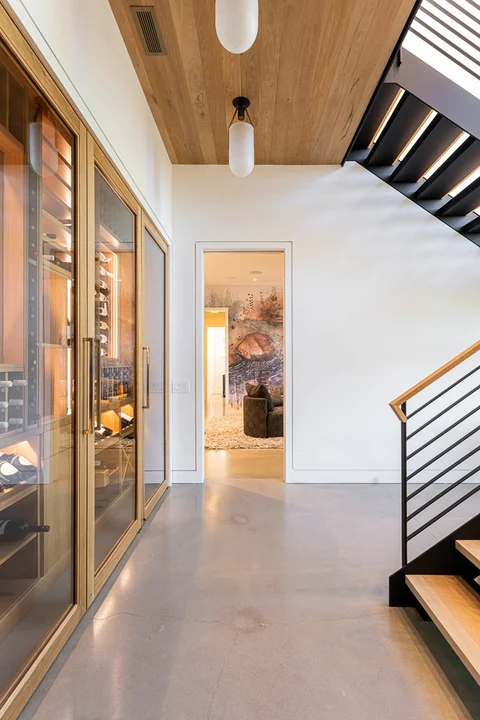 Landing at bottom of stairs in Lake Toxaway Modern Custom Home