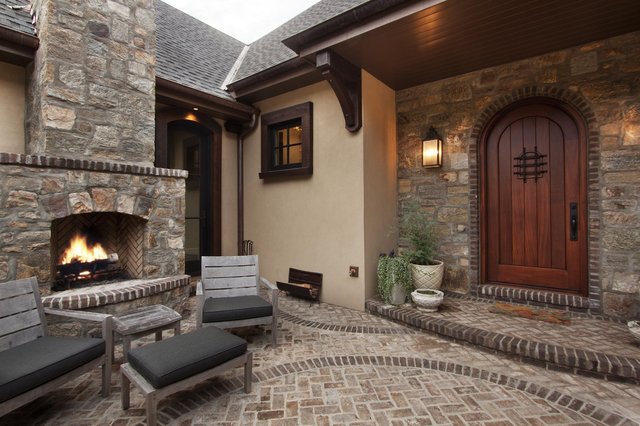 Cove Courtyard stone courtyard with built-in fireplace